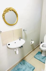 a bathroom with a sink and a mirror on the wall at Graceful Getaway Air B&B in Rundu