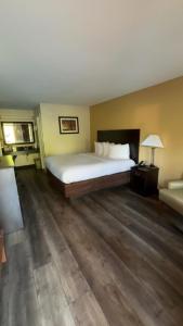 a hotel room with a bed and a desk with a lamp at ArabKnightsInn in Arab