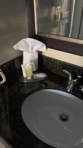 a bathroom counter with a sink and a mirror at ArabKnightsInn in Arab