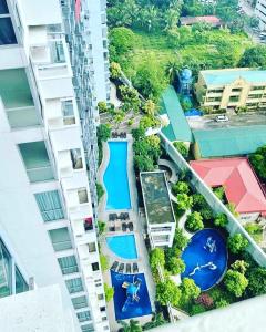 an aerial view of a building with a swimming pool at Manhattan Heights TowerD-Unit5 Viv's room Studio type in Manila