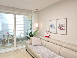 a living room with a couch and a window at Gyeongju Florian Stay Close Explore More in Gyeongju