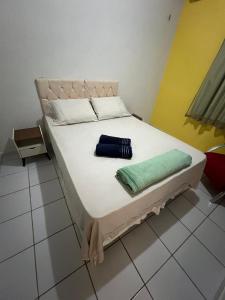 a bed with two pillows on it in a room at Apartamento Solaris in São Luís