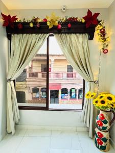 a window with a view of a building at Hotel New York in Santa Rosa de Copán +7 photos