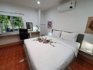 a large white bed in a room with a window at Filou Villas in Ko Chang