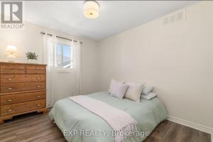 a bedroom with a bed and a dresser and a window at Luxurious home in Belleville in Bélanger