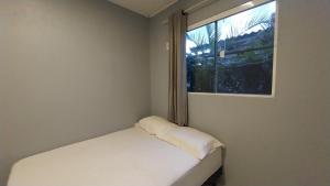 Ένα ή περισσότερα κρεβάτια σε δωμάτιο στο Casa com ar condicionado