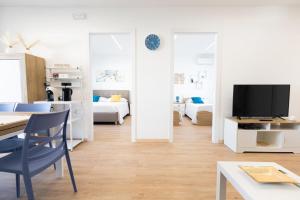 a living room with a table and a tv in a room at Pietrazzurra in Squinzano