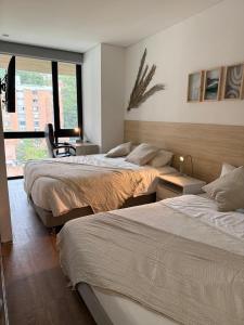 En eller flere senge i et værelse på NOK Beautiful 2BR Apartment in El Poblado