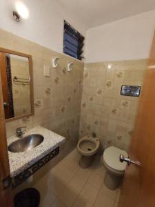 a bathroom with a sink and a toilet at Daymán Apart Hotel in Termas del Daymán +70 photos