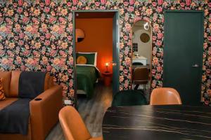 a room with a room with a bed and a table at Bloum at 22, City Views and Wonderland Vibes! in Hatillo