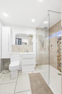 Ένα μπάνιο στο M5 Spacious Stylish Full Kitchen 2Bath Premium Beds Electric Sofa Recliners Smart TVs Netflix Underfloor Heating Instant Hot Water FastWifi