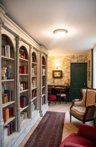 a library with bookshelves and a green door at Maison la Louise in Ligny-en-Barrois
