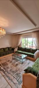 a living room with a couch and a glass table at guiliz in Marrakech