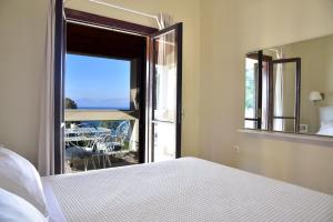 a bedroom with a bed and a window with a view at Vista Petros in Apraos