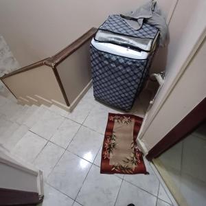 an overhead view of a staircase with a trashcan and a floor at Cozy Mini Villa with a backyard in 6th Of October