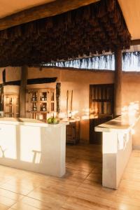 a kitchen with a white island in a room at Mōmento Itamambuca in Ubatuba
