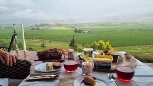 a table with food and a view of a field at Fairhall view 