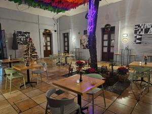 a restaurant with tables and chairs and a christmas tree at BKL Hotel Oaxaca in Oaxaca City