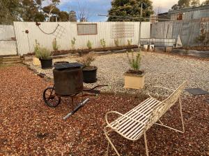 a chair and a grill in a garden at The Little House in Golden Square +5 photos