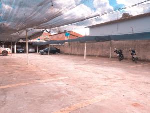 a parking lot with two motorcycles parked under a tent at Hotel Minas Brasil in Salinas