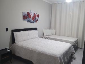 Ένα ή περισσότερα κρεβάτια σε δωμάτιο στο Pousada Ferreira-TJ