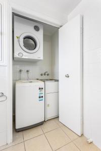 a kitchen with a refrigerator and a microwave at 'Villa Mar Colina U12' Coastal Escape, Yeppoon in Yeppoon