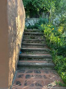 a set of stone steps leading up to a building at Casa Puna in Alta Gracia