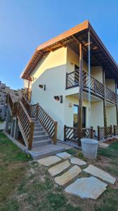 a house with a staircase leading to the front of it at Pousada do Barão in Lindóia
