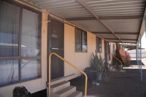 a building with awning and stairs next to a building at Miners Rest Units in Mount Magnet