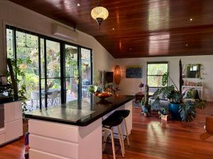 a kitchen with a large island with a counter top at Byron Bay Hinterland Sanctuary in Federal