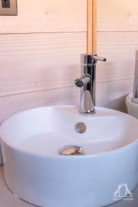 a white sink with a faucet in a bathroom at Casas Arco Jardin in Castro +29 photos