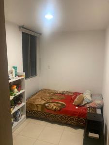 a small bedroom with a bed in a room at Tucurumbi entrada quimbaya in Quimbaya
