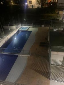 an empty swimming pool at night with lights at Tucurumbi entrada quimbaya in Quimbaya