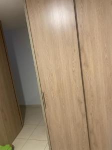 a wooden cabinet in a room with a door at Tucurumbi entrada quimbaya in Quimbaya