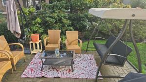 a group of chairs and a table on a patio at Bright Private Room in Echo Valley Home in Victoria