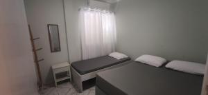 Ένα ή περισσότερα κρεβάτια σε δωμάτιο στο Apartamento Espaçoso a 300m da praia Enseada, Guaruja