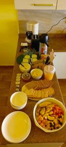 a counter topped with bowls and plates of food at Casa Rumi - Guesthouse in La Paz