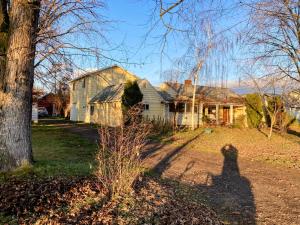 a shadow of a person standing in front of a house at The Plain Jane-Simple Comfort in Walla Walla Valley Wine Country in Walla Walla
