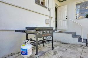 a grill sitting outside of a house with a stairs at Villa Riviera Beach -4Bdr Relaxing Retreat By Viac in Riviera Beach