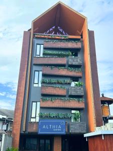 a building with plants on the side of it at Althia Capsule Quarters in Badung