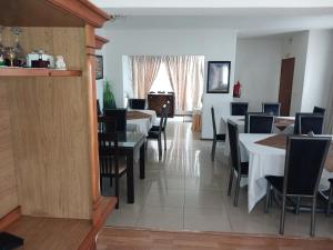 a dining room with tables and chairs and a window at Moshitametsi Guesthouse in Kempton Park
