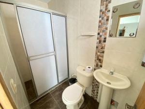 a bathroom with a toilet and a sink at Apartamento la Isla 2-Coveñas in Coveñas +35 photos