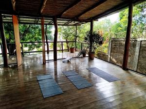 a room with yoga mats on a wooden floor at Casa Nalu in San Juan del Sur +10 photos
