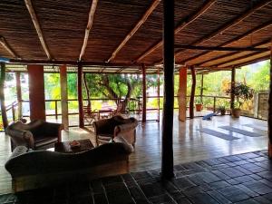 a living room with couches and chairs in a building at Casa Nalu in San Juan del Sur