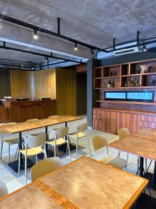 a dining room with tables and chairs and shelves at Althia Capsule Quarters in Badung +36 photos