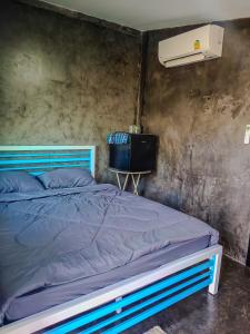 Ένα ή περισσότερα κρεβάτια σε δωμάτιο στο ก้านกล้วยโฮมสเตย์