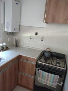 a kitchen with a stove with a tea pot on it at Selene in Villa Rumipal