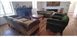 a living room with four couches and a fireplace at Casona Starlight in Melipilla