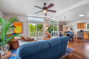a living room with a blue couch at Trailblazer Lodge - Upscale, hot tub, trail, game room, wifi, fire pit, bar, pool table, king bed, view, pet friendly in Berkeley Springs