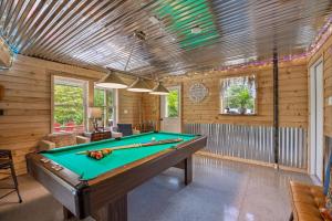 a billiard room with a pool table in it at Trailblazer Lodge - Upscale, hot tub, trail, game room, wifi, fire pit, bar, pool table, king bed, view, pet friendly in Berkeley Springs
